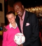 Dave Bennett presents a prize football to a young fan