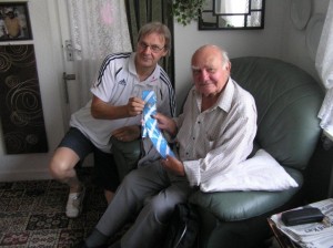 Jim presents Peter (right) with his tie